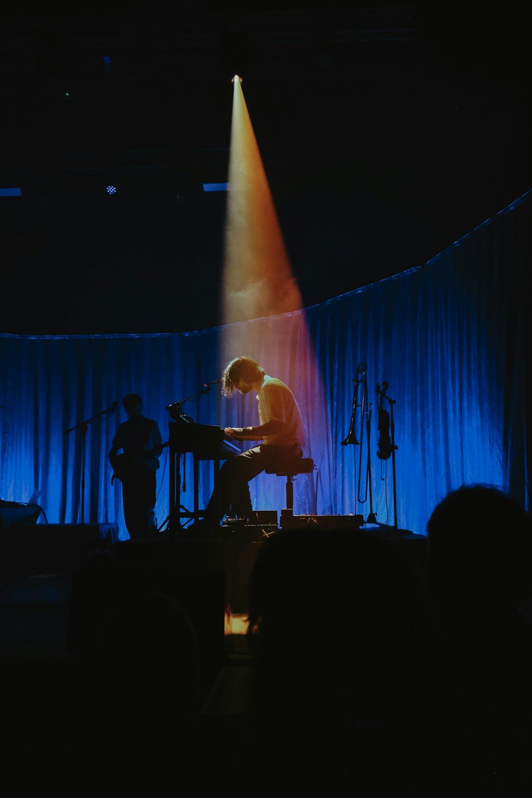 musician playing guitar on stage